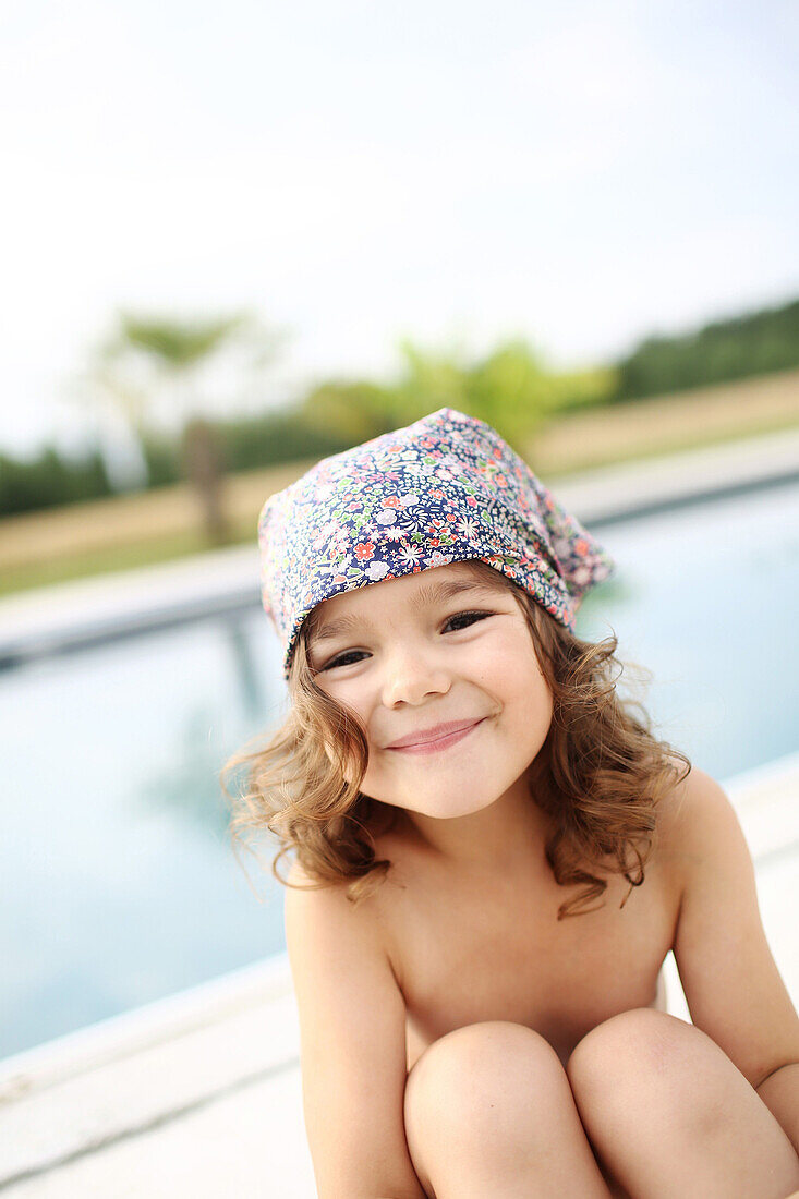 Portrait of a 4 years old girl near a pool