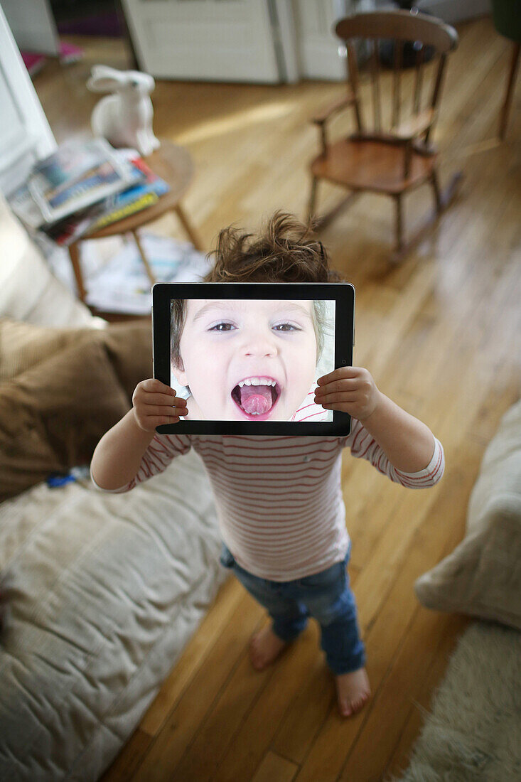 Little boy playing with a tablet