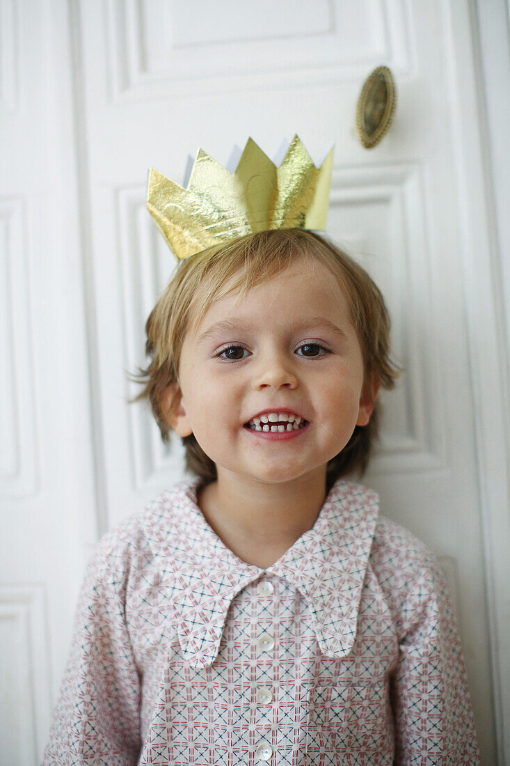 Little boy with a paper crown on the head
