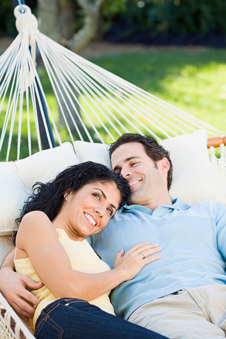 Couple relaxing in hammock