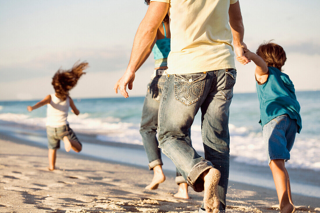 Family running on beach – License image – 71027701 lookphotos