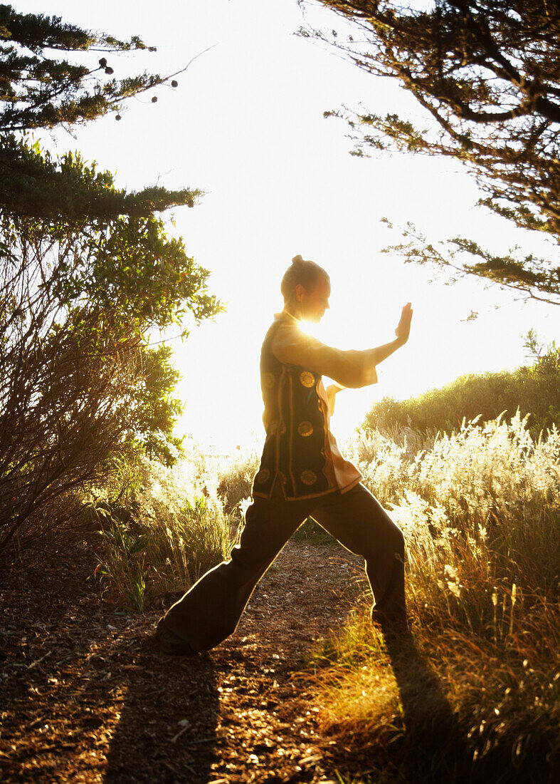 Caucasian man practicing tai-chi in remote area