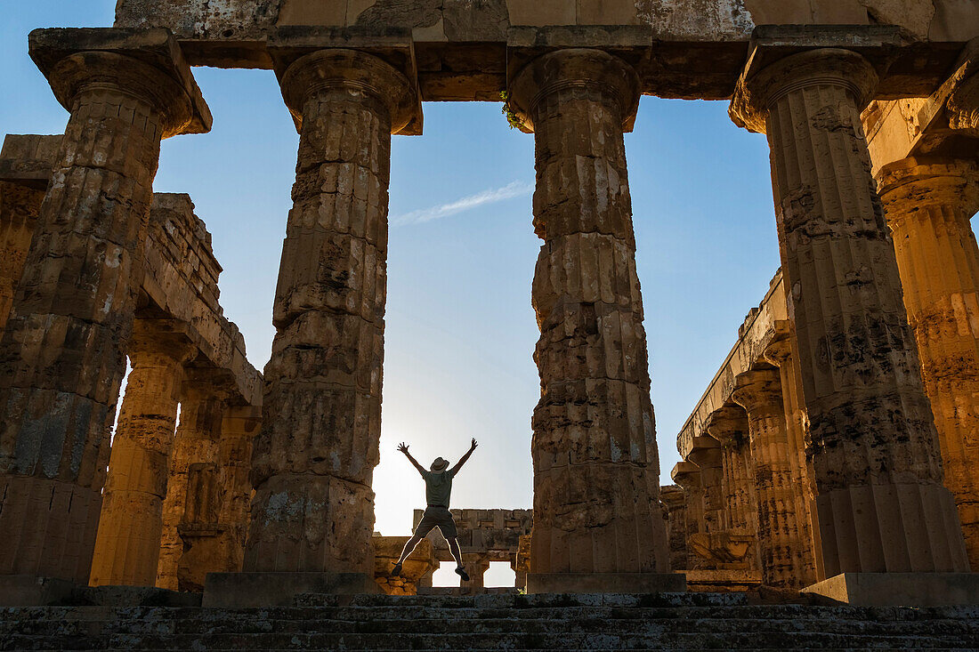 Caucasian man standing in Temple at Selinunte ruins, Selinunte, Sicily, Italy