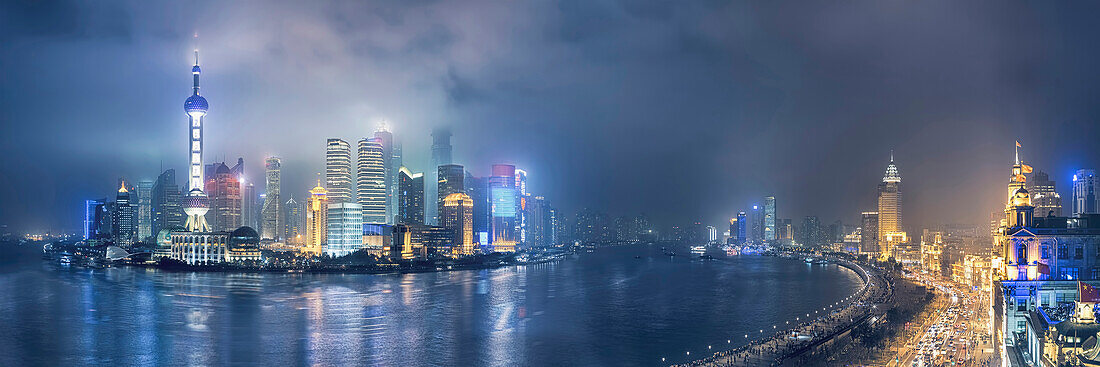 City skyline lit up at night, Shanghai, China