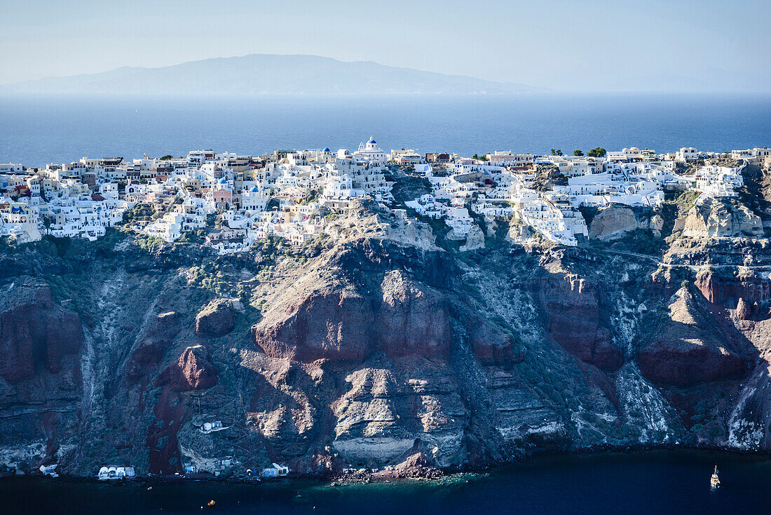 Aerial view of city built on rocky coastline, Oia, Egeo, Greece