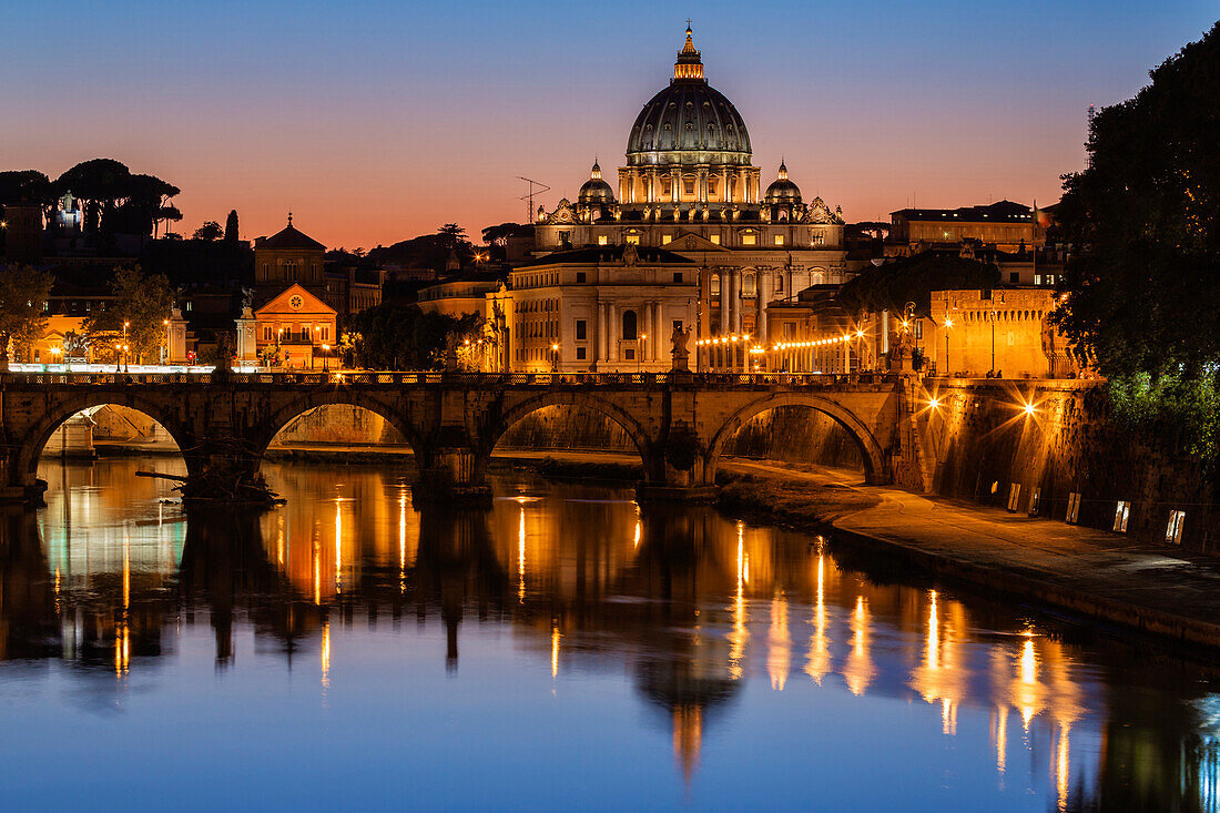 St. Peter's Basilica and Tiber River illuminated at dusk, Rome, Lazio, Italy