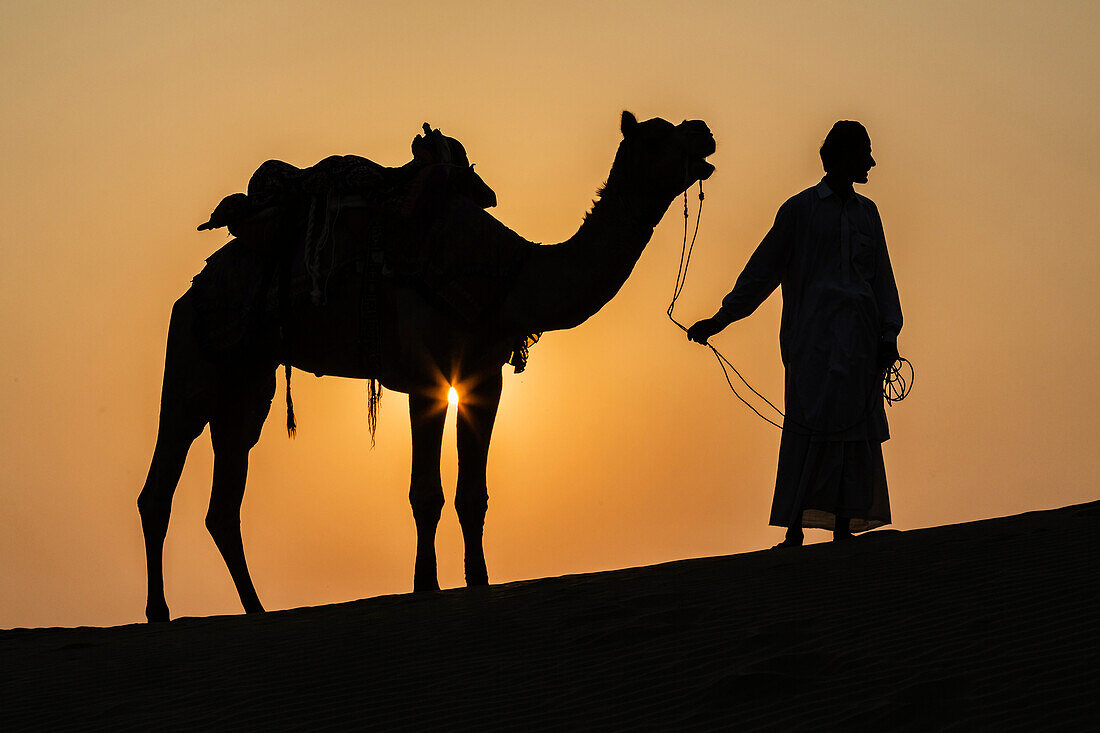 Silhouette of camel driver in Thar Desert, Jaisalmer, Rajasthan, India