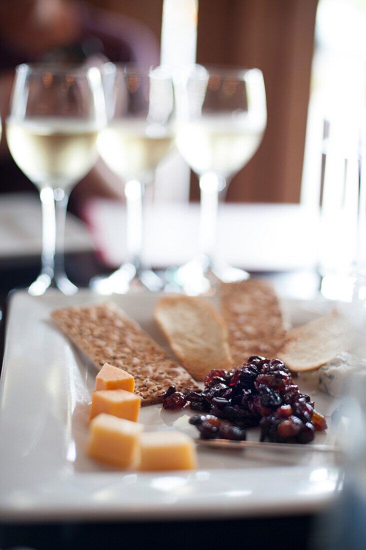 Plate of Appetizers with Glasses of White Wine in Background