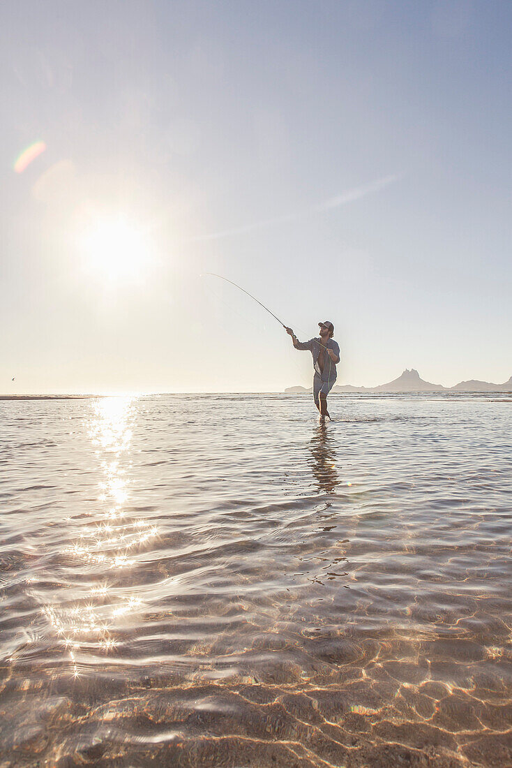 Man Fly-fishing in Shallow Water