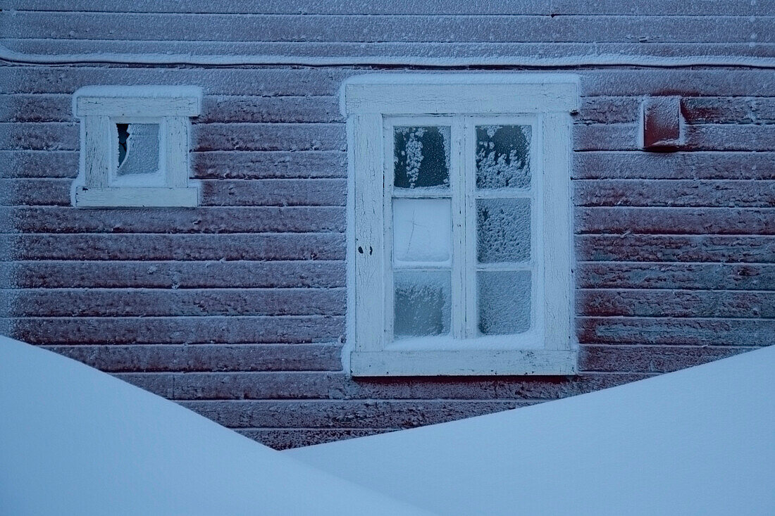 Windows of Red House Covered in Snow and Ice