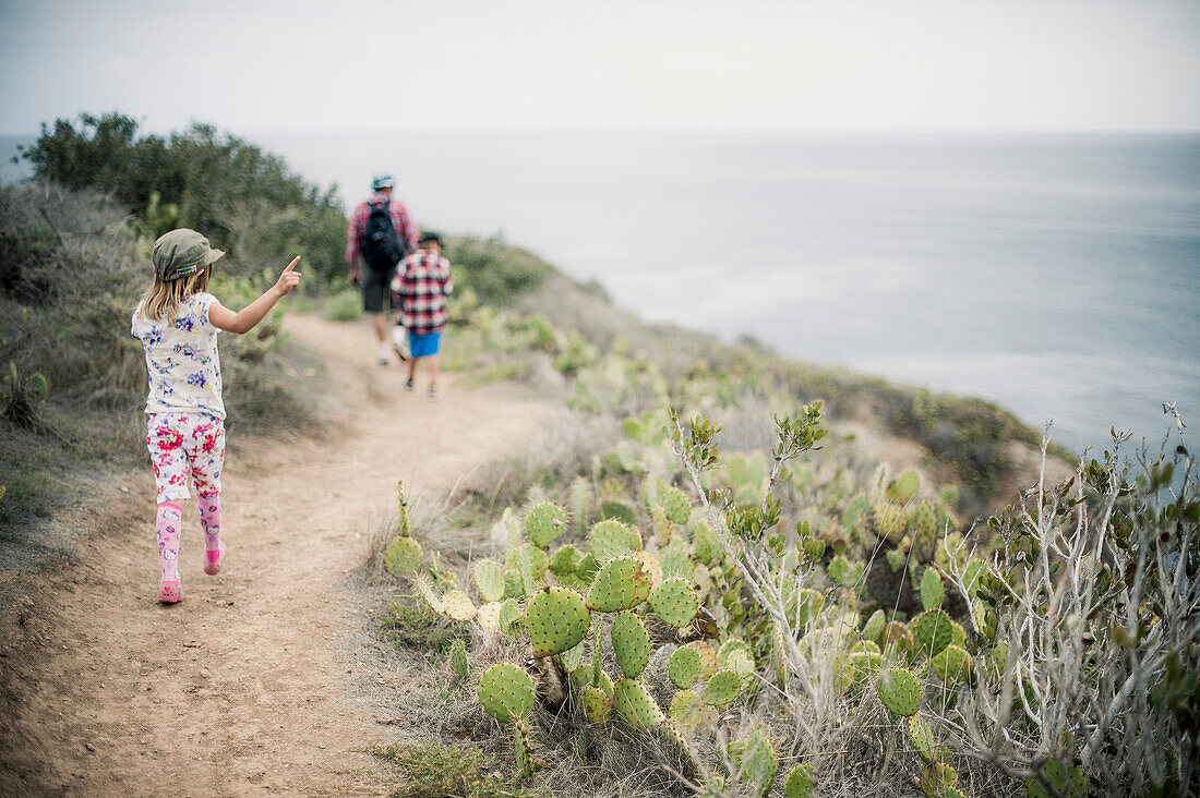 Father and Two Children on Trail on Coastal Cliff