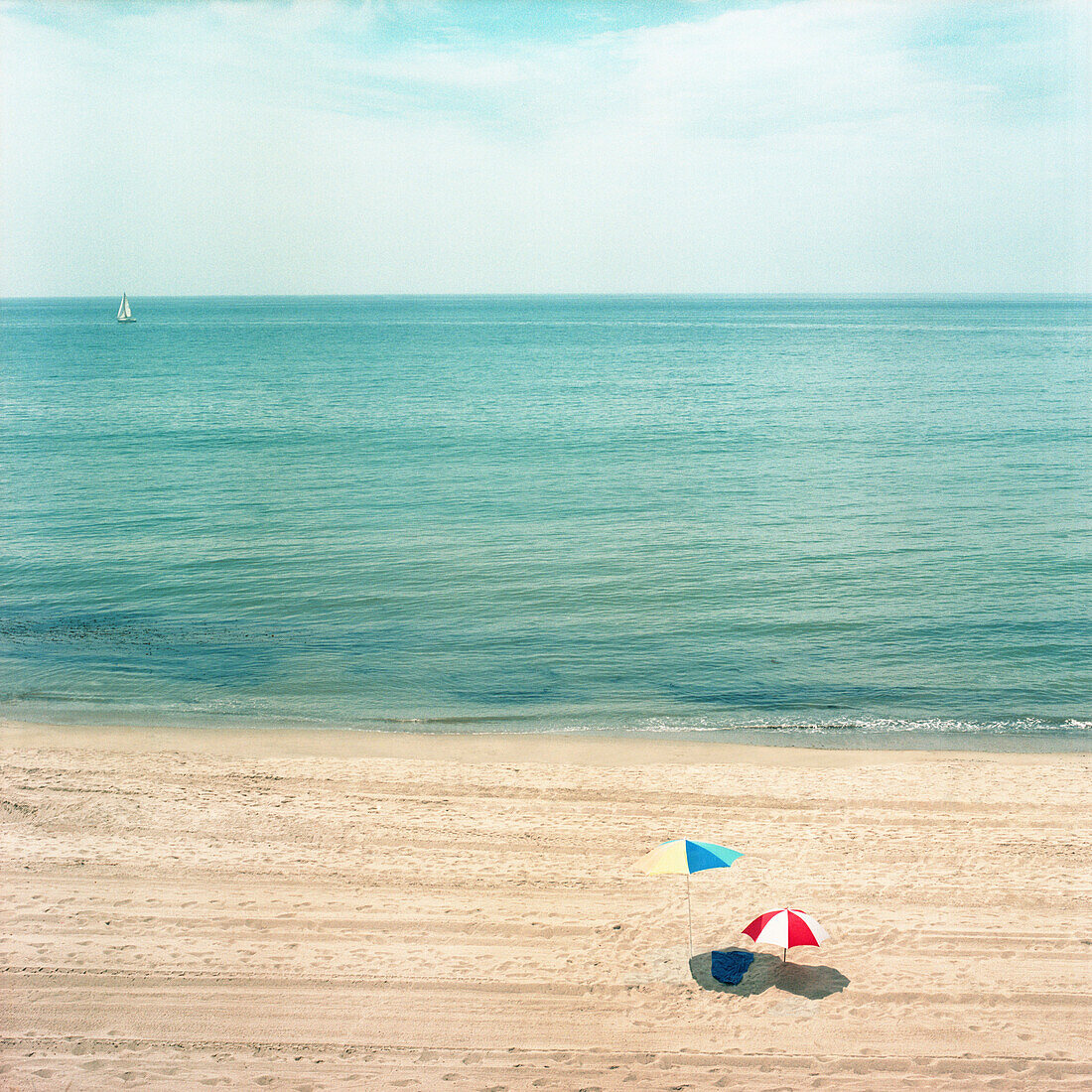 Two Umbrellas on Sandy Beach with Ocean in Background, High Angle View, Los Angeles, California, USA