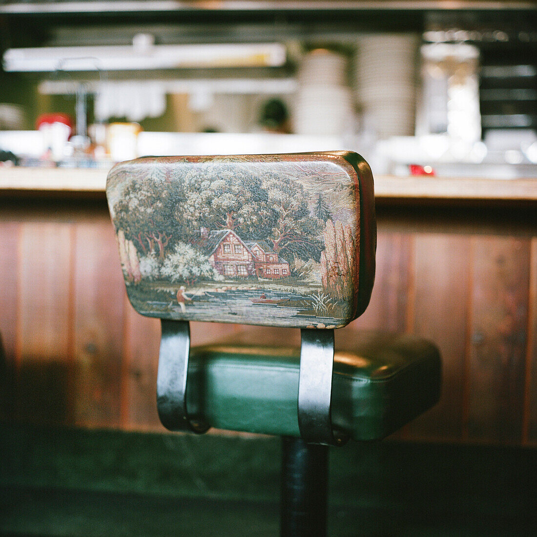 Restaurant Counter Stool with Painting of Cottage and Man Fishing on Back Support
