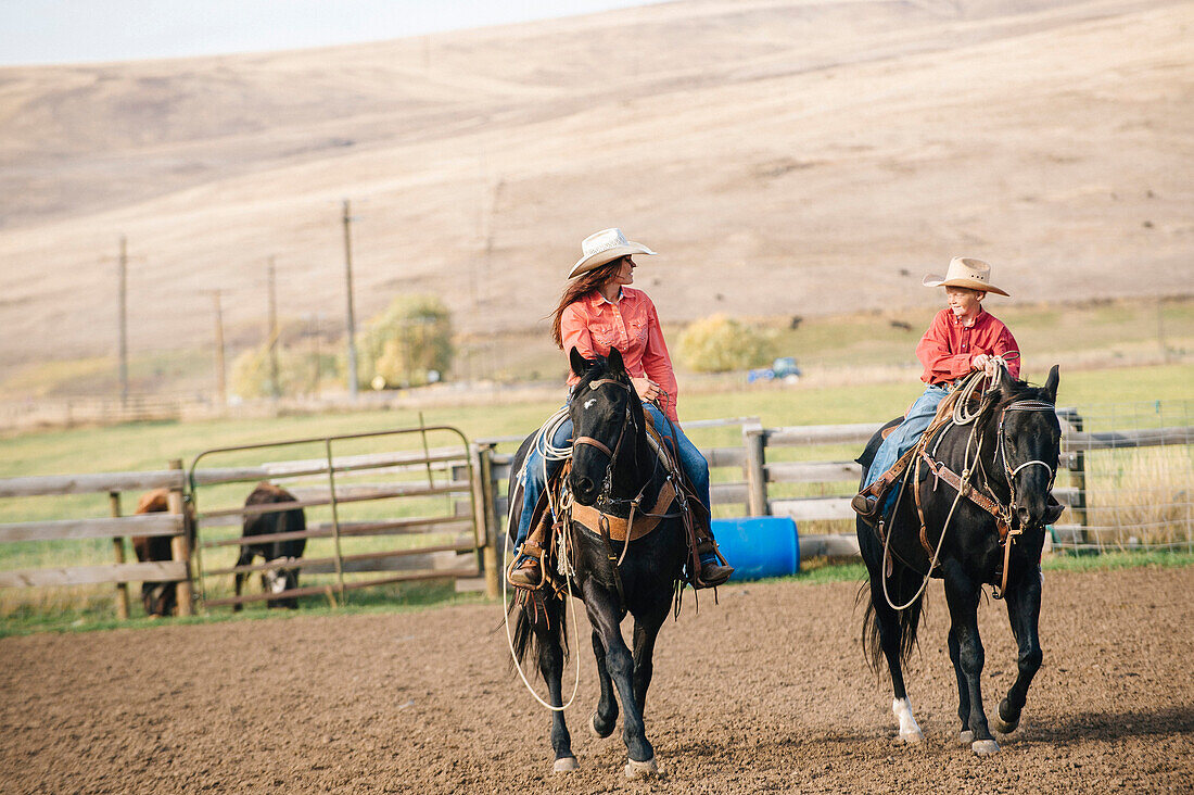 Caucasian mother and son riding horses on ranch, Jospeh, Oregon, USA