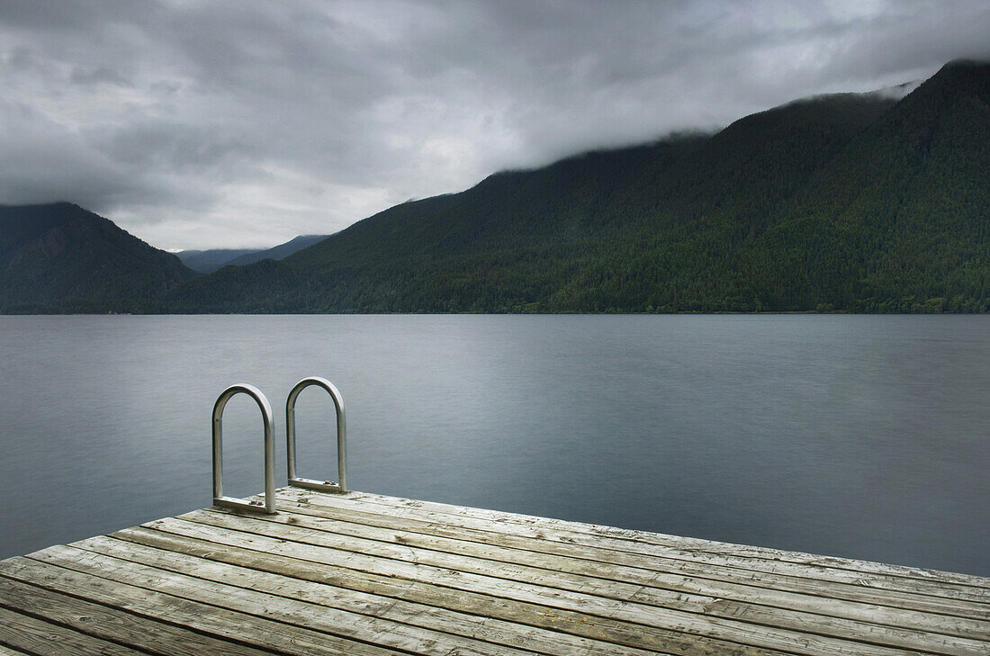 Ladder on wooden pier at still remote lake, Olympic National Park, Washington, USA
