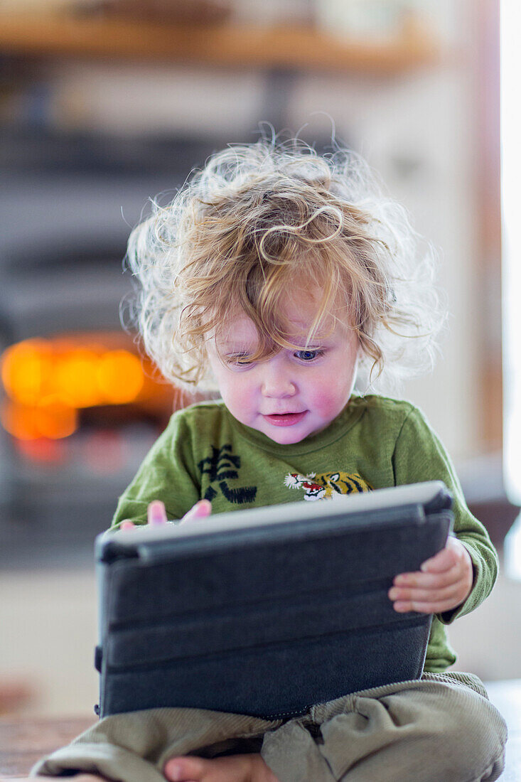 Caucasian baby boy using digital tablet, C1