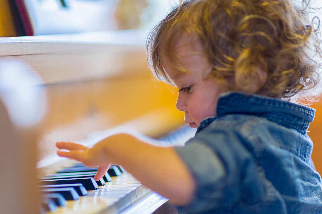 Caucasian baby boy playing piano, C1