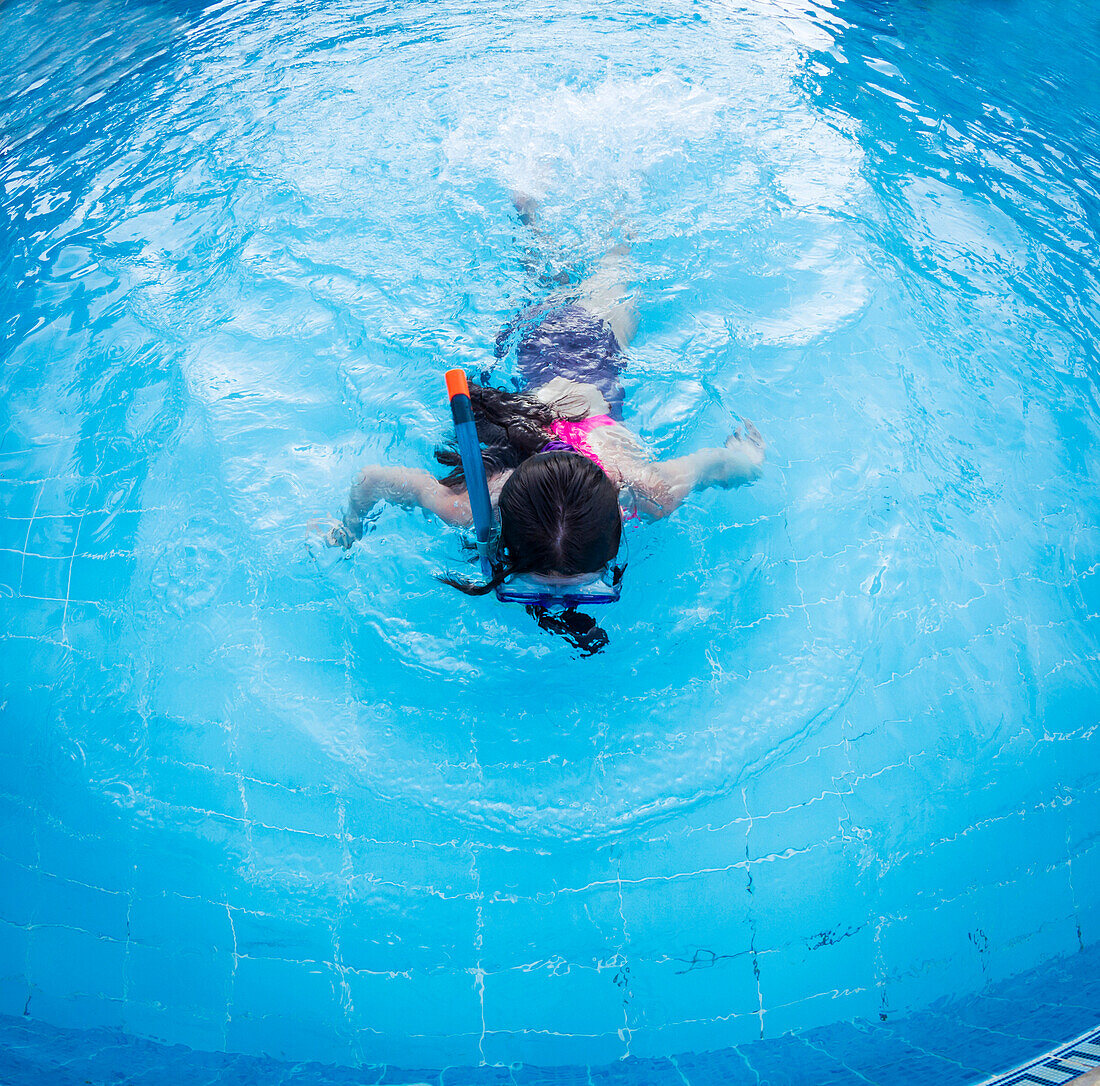 Caucasian girl snorkeling in swimming pool, C1