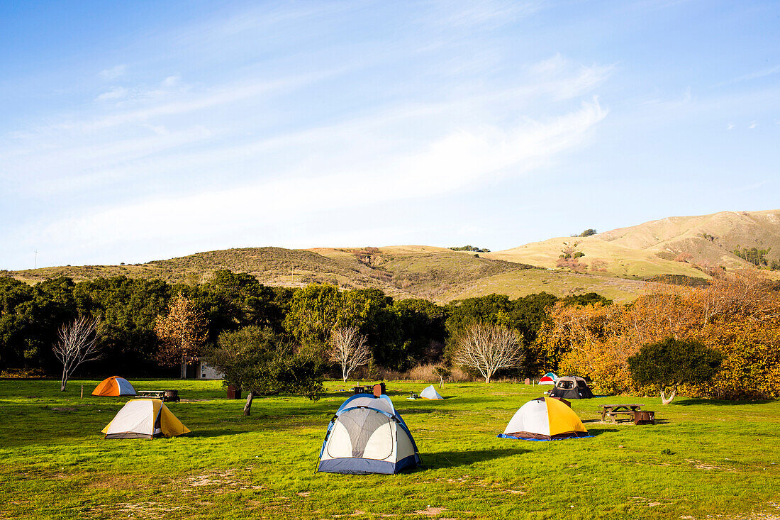 Camping tents in remote grassy field, Big Sur, California, United States