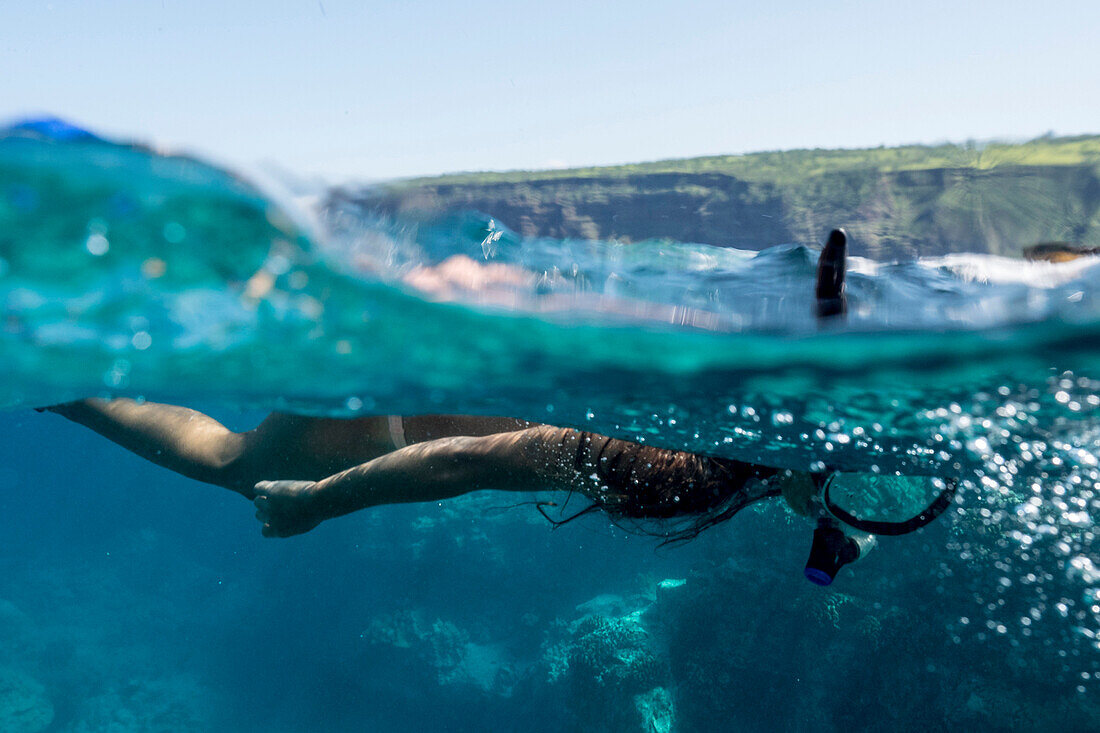 Mixed race woman snorkeling in tropical ocean, The Big Island, Hawaii, United States
