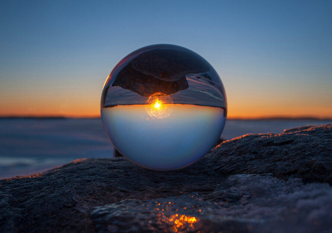 Close up of sunset horizon inverted in glass sphere, Gananoque, Ontario, canada