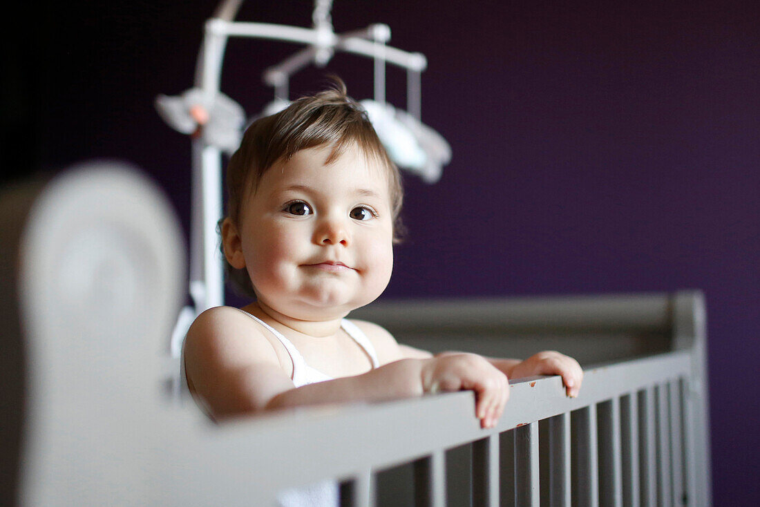 A baby girl in her crib