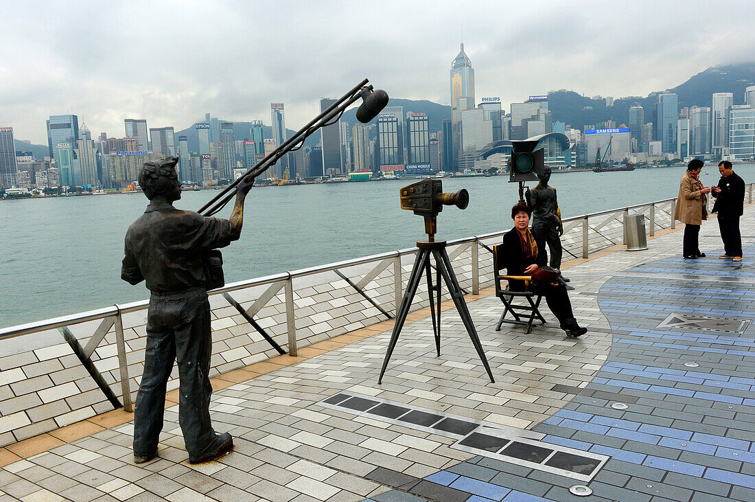 Statue and skyline along the Avenue of Stars attraction near the waterfront at Tsim Sha Tsui. The promenade honours celebrities of the Hong Kong industry as the famous city attraction