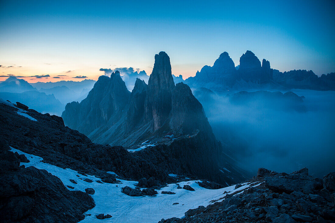 The Cadini di Misurina emerging from the fog after sunset, in a typical Dolomitic landscape, Dolomites, South Tyrol, Italy, Europe