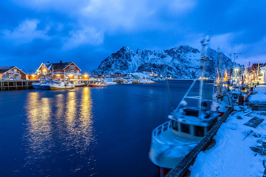 The lights of the harbor of Henningsvaer, the most important in the Lofoten, lit at the blue hour, Lofoten Islands, Arctic, Norway, Scandinavia, Europe