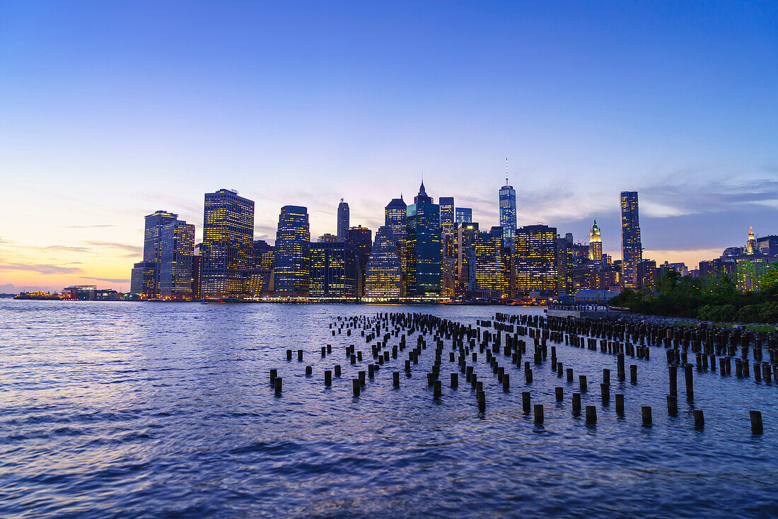 Lower Manhattan skyscrapers including One World Trade Center at sunset from across the East River, Financial District, Manhattan, New York City, United States of America, North America