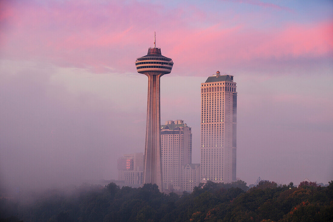 Mist from Horseshoe Falls swirling in front of Skylon Tower at dawn, Niagara Falls, Niagara, border of New York State and Ontario, Canada, North America
