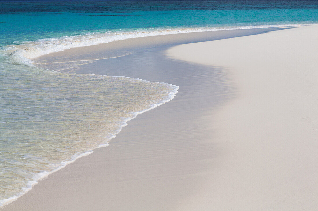 The crystal clear water of the Indian Ocean and a deserted beach on an island in the Maldives, Indian Ocean, Asia