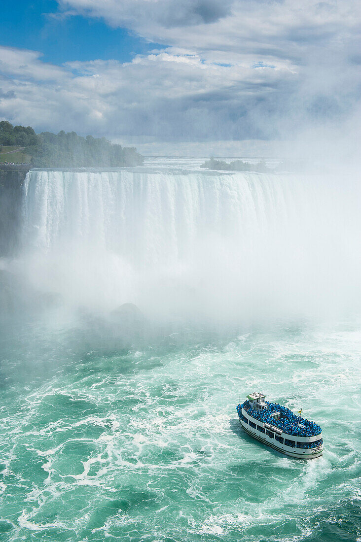 Tourist boat in the mist of the Horseshoe Falls, or Canadian Falls, Niagara Falls, Ontario, Canada
