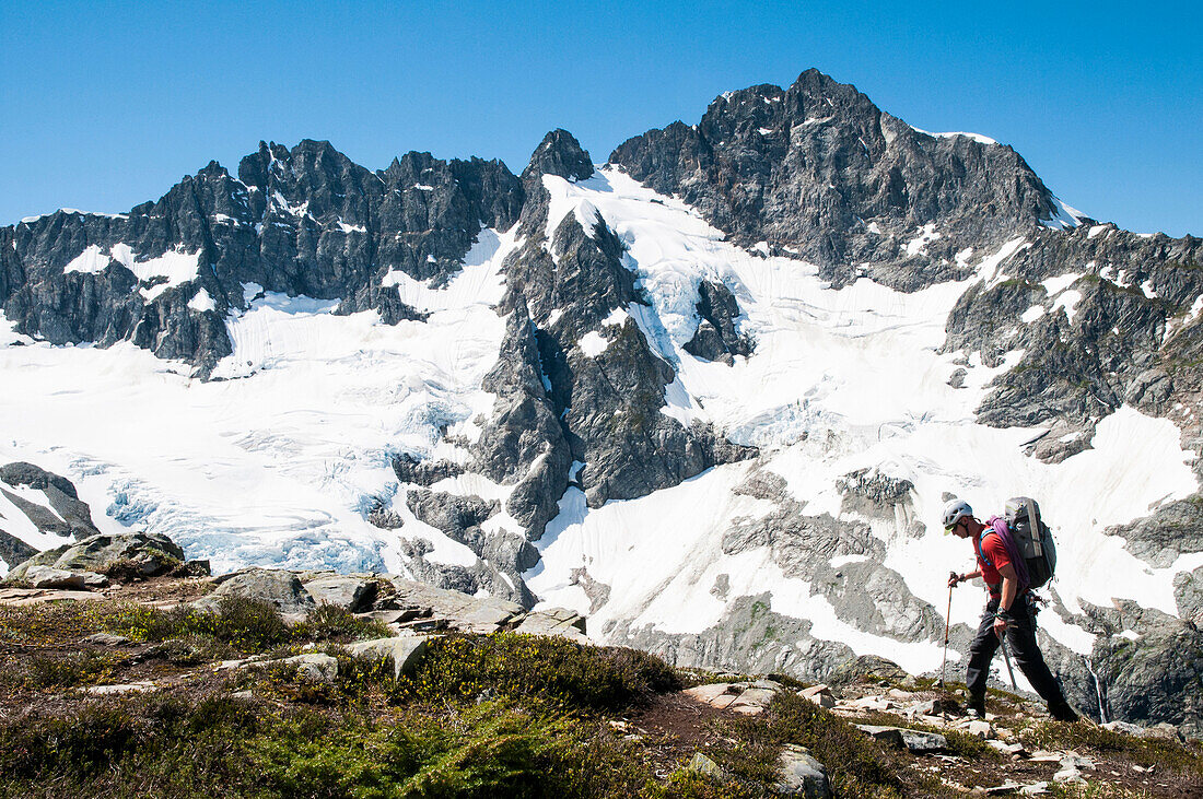 Climber traversing in front of Mount Formidable during the Ptarmigan Traverse , North Cascades, Washington