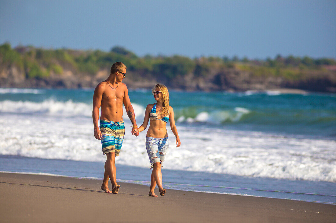 Couple are walking on the beach in Bali. Indonesia