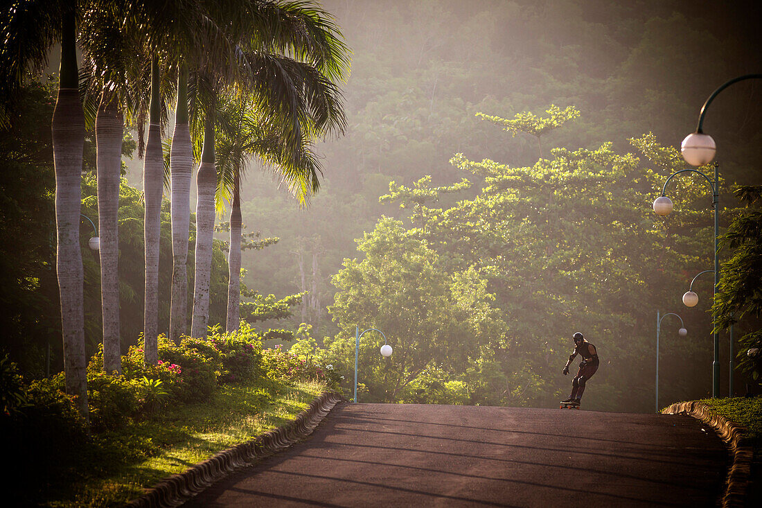 Man riding on a longboard skate.