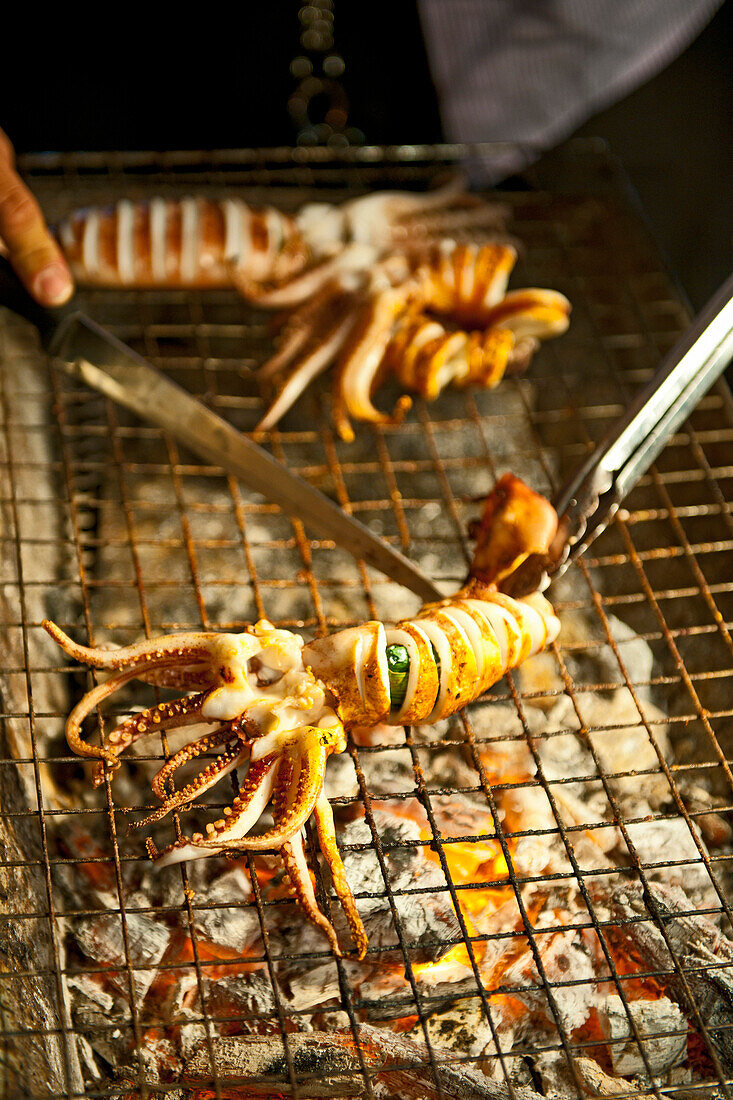 squid on a barbeque at a street market in Thailand