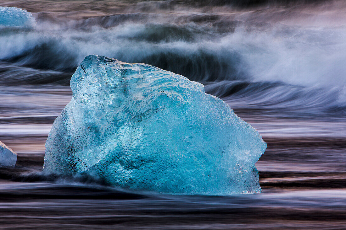 Glacial ice from Breiðamerkurjökull sits on the beach  of the coast at Breiðamerkursandur, Iceland, also known as the Jokulsarlon.