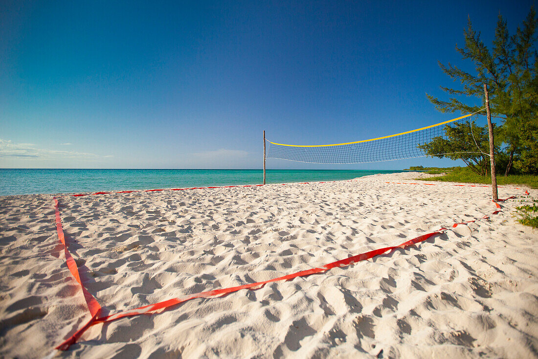 A beach volleyball court set up beside the ocean on Playa La Jaula beach, Cayo Coco, Cuba.