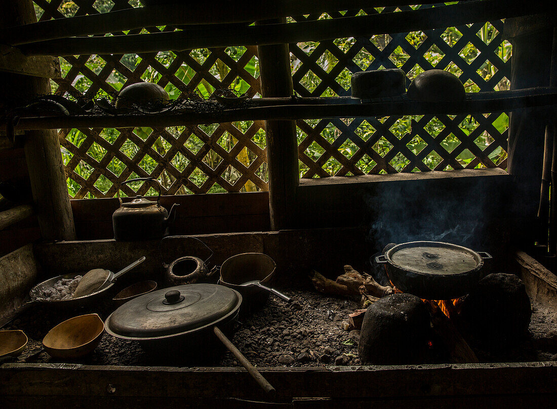 Pots and pans sit over a fire in the West coast of Dominica
