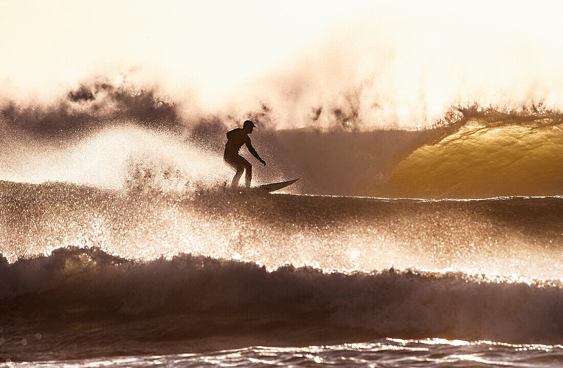surfer in heavy surf at dusk