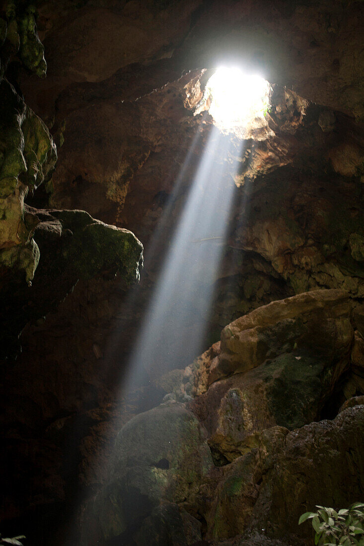 A ray of sun light enters the Calcehtok Mayan caves near Oxkintok in Yucatan Peninsula, Mexico. These caves are where for the ancient Mayans an entrance to Xibalba, the underworld.