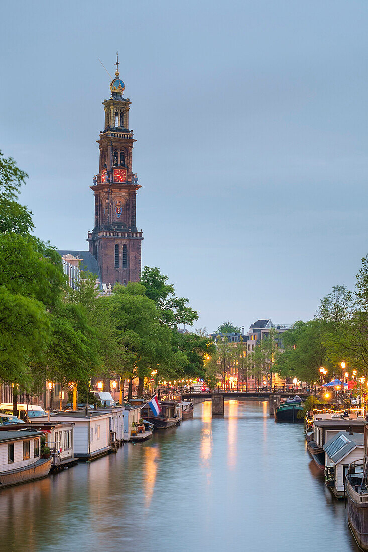 Prinsengracht canal at dusk with Westerkerk in distance, Amsterdam, North Holland, Netherlands