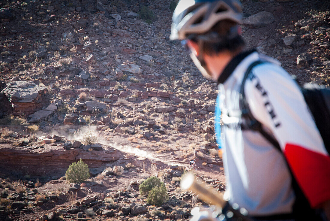 Riders descend into the canyon on  mountain bikes while touring the White Rim Trail near Moab, Utah.