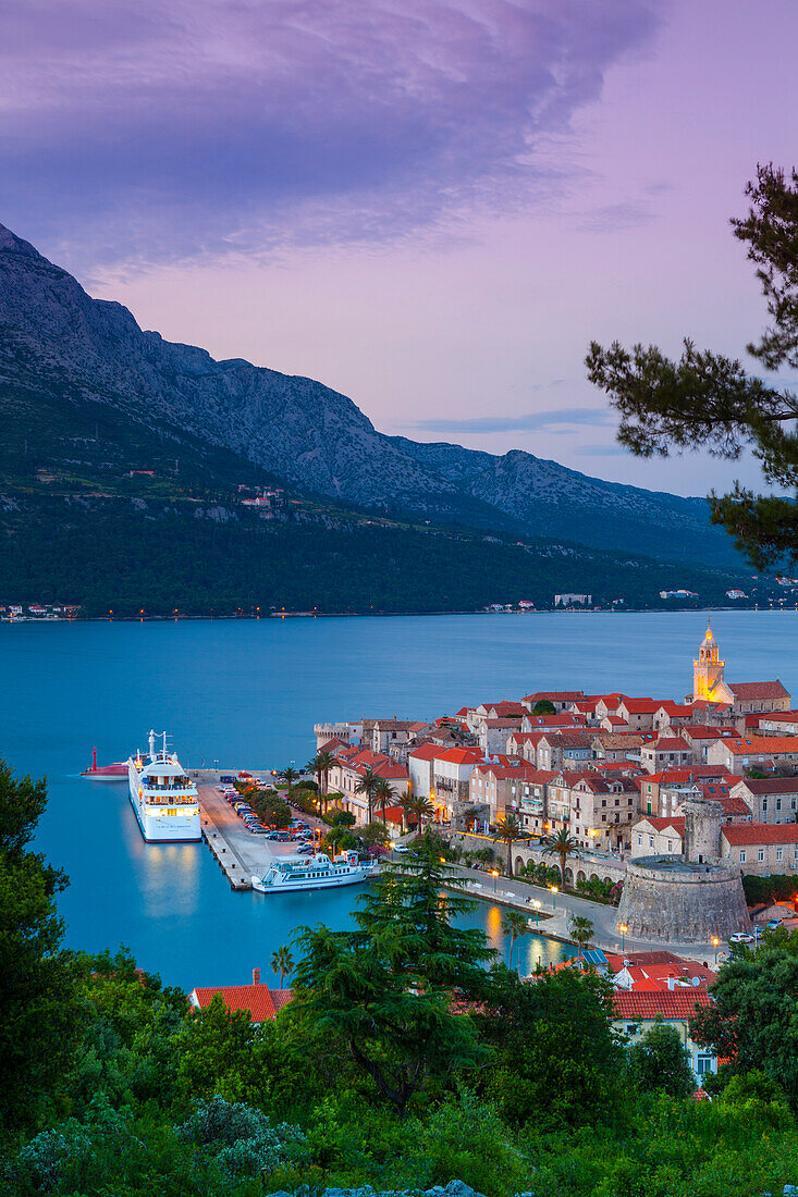 Elevated view over Korcula's picturesque Stari Grad (Old Town) illuminated at dusk, Korcula Town, Korcula, Dalmatia, Croatia, Europe