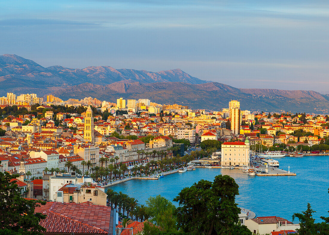 Elevated view over Split's picturesque Stari Grad and harbour illuminated at sunset, Split, Dalmatia, Croatia, Europe