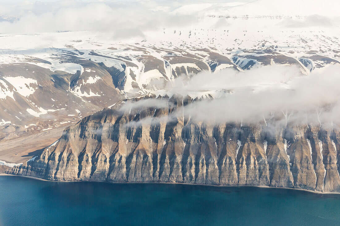 Aerial view of mountains, glaciers and ice fields on the west coast of Spitsbergen on a commercial flight from Longyearbyen to Oslo, Svalbard, Norway, Scandinavia, Europe