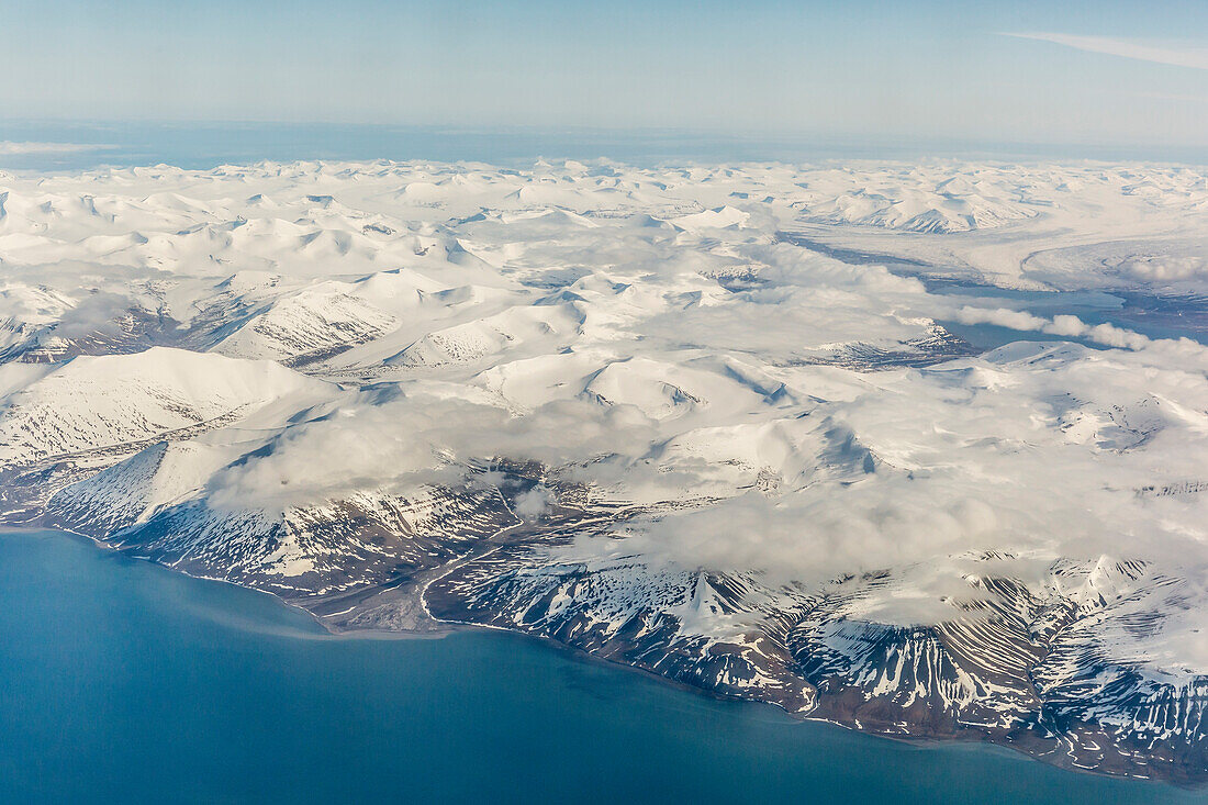 Aerial view of mountains, glaciers and ice fields on the west coast of Spitsbergen on a commercial flight from Longyearbyen to Oslo, Svalbard, Norway, Scandinavia, Europe