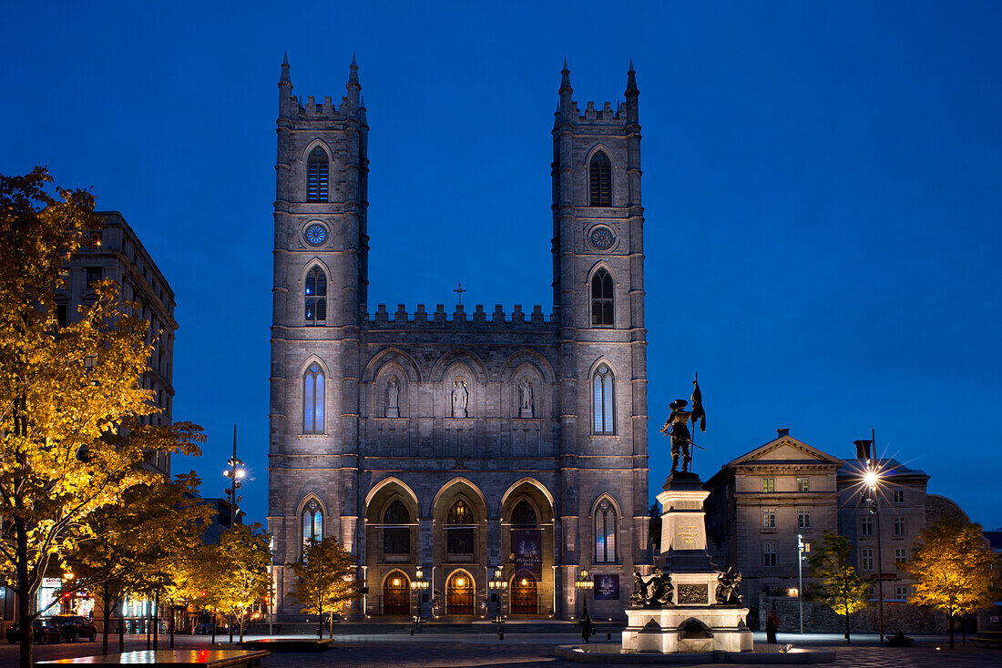 The Notre Dame Cathedral at dusk in the Place d'Arms, Montreal, Quebec Province, Canada, North America