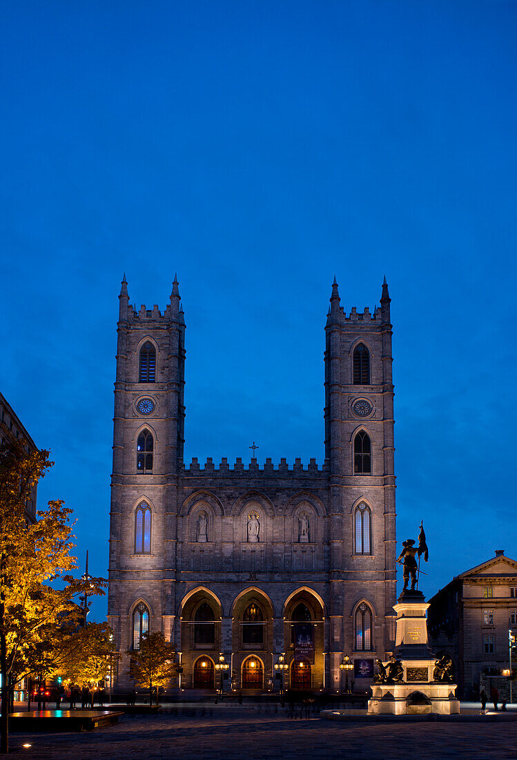 The Notre Dame Cathedral at dusk in the Place d'Arms, Montreal, Quebec Province, Canada, North America